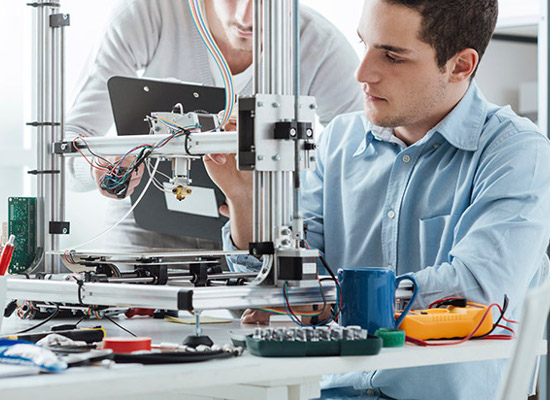 Engineering students using an innovative 3D printer in the laboratory